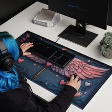 Load image into Gallery viewer, The Celestial Winged Wand Gaming Mouse Pad styled on a cozy gaming desk setup, paired with a pastel keyboard and mouse, creating a magical and aesthetic workspace.
